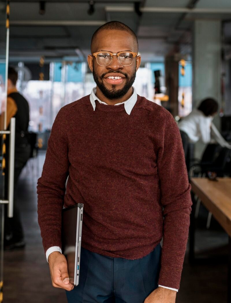 smiley-man-posing-while-holding-laptop