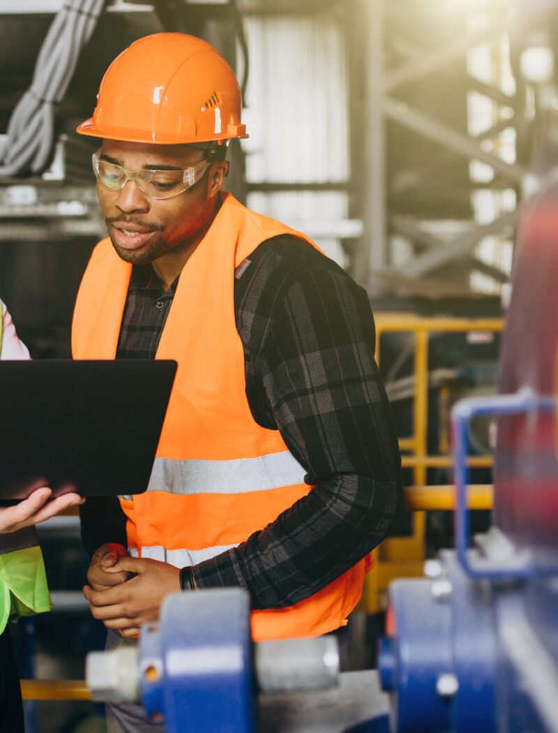 Inspector and african american worker in a factory